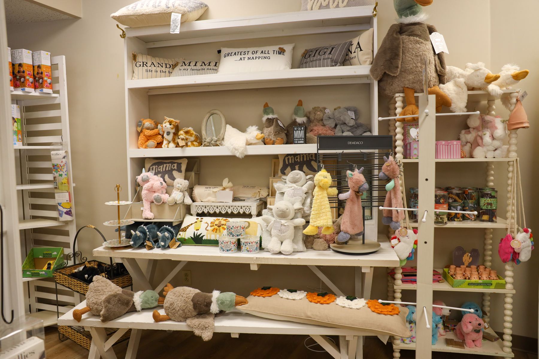 A display table and shelves of plush animals and children's gifts