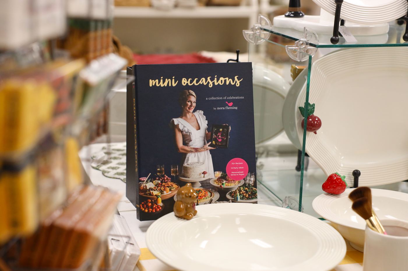 The Mini Occasions entertaining book displayed with Nora Fleming serveware