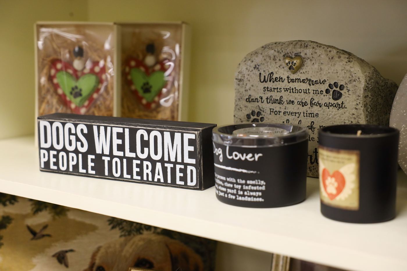 A Dogs Welcome, People Tolerated sign, a dog lover candle, and a pet remembrance stone