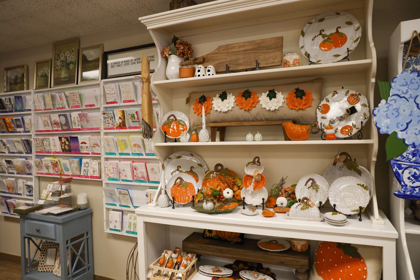 Fall greeting cards beside shelves of pumpkin décor