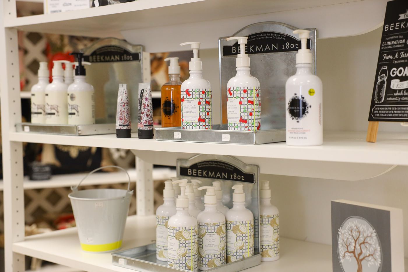Beekman 1802 goat milk lotions and soaps on white shelves