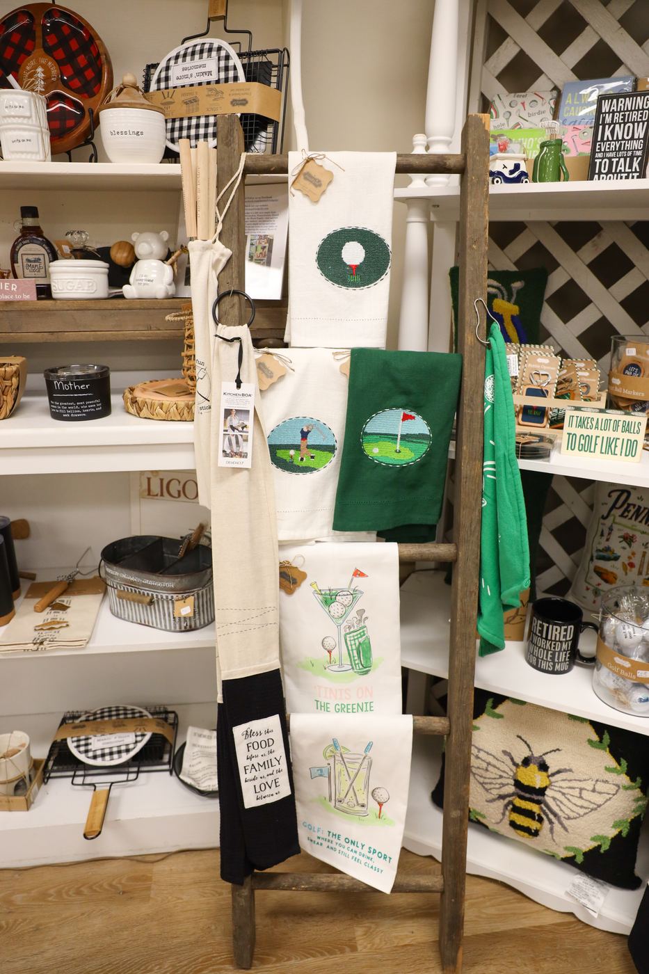 Kitchen towels draped over a wooden ladder display