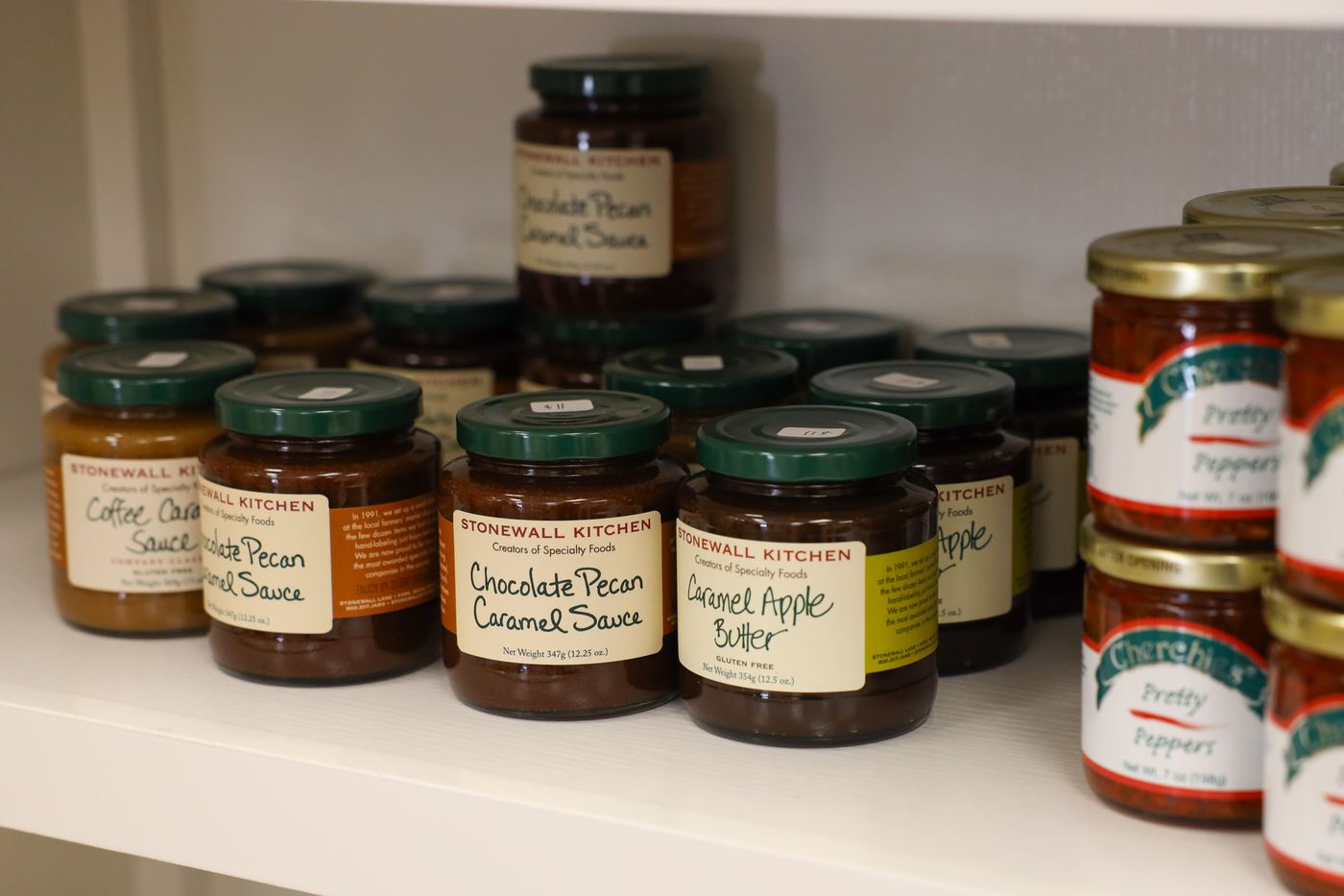 Stonewall Kitchen jams and dessert sauces on a shelf